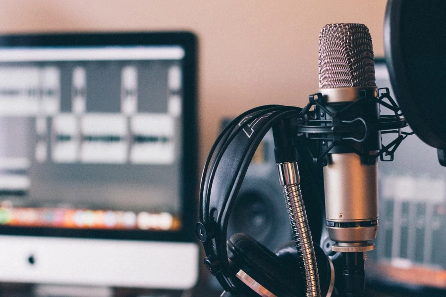 Microphone and headphones in front of a computer