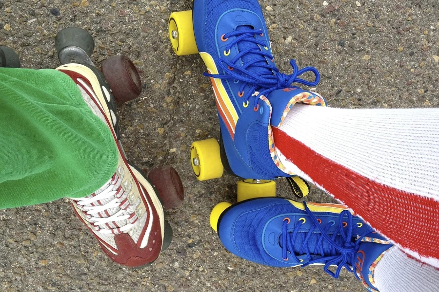 Overhead shot of two people’s feet in roller skates