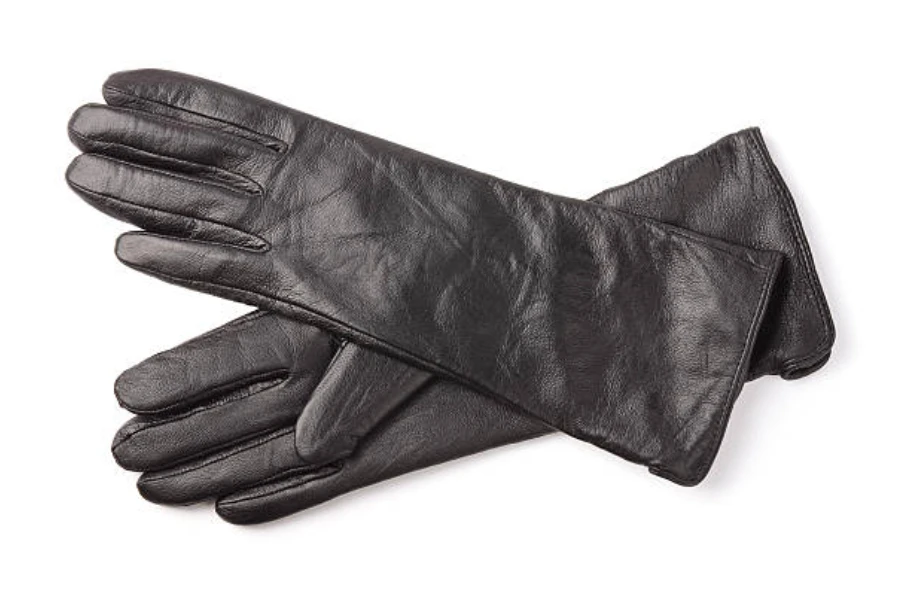 Pair of long black winter gloves on a white background