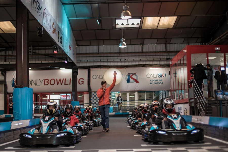 Set of racers starting to pull away in an indoor go kart track