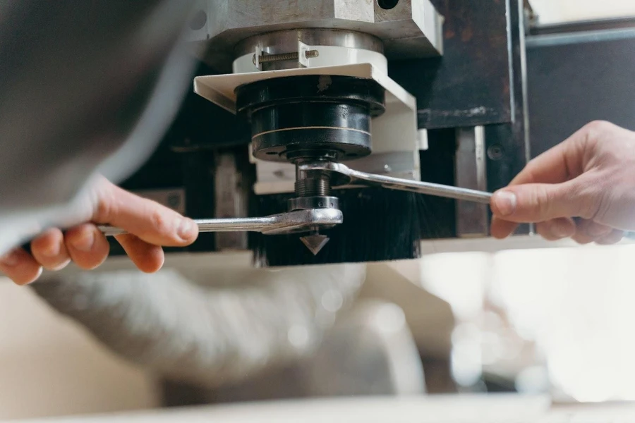 Someone tightening a CNC machine