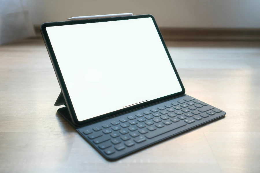Tablet on a table with pencil and keyboard