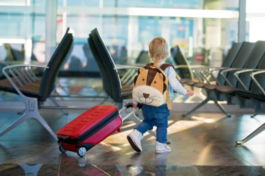 Toddler wearing an animal face backpack at the airport