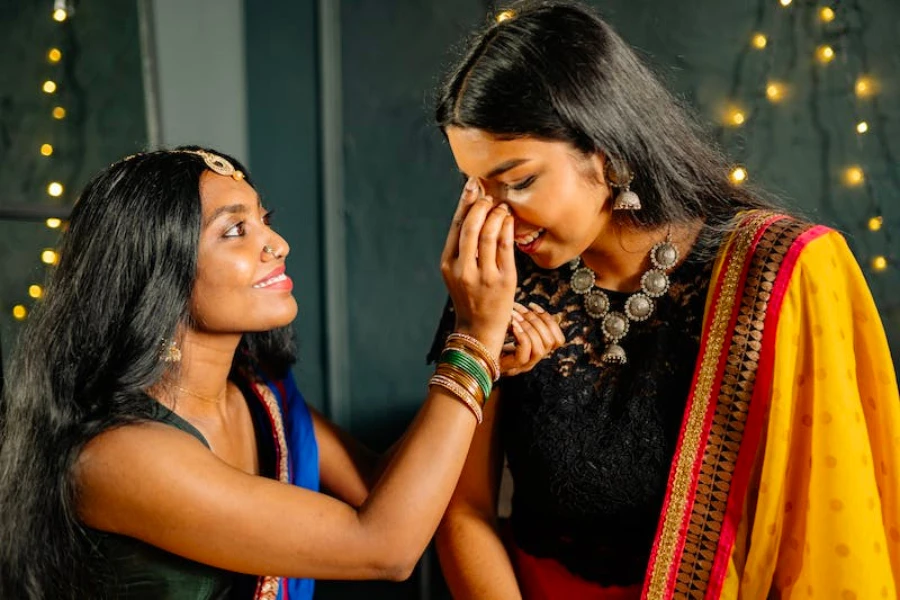 Two Indian women wearing traditional clothing and makeup