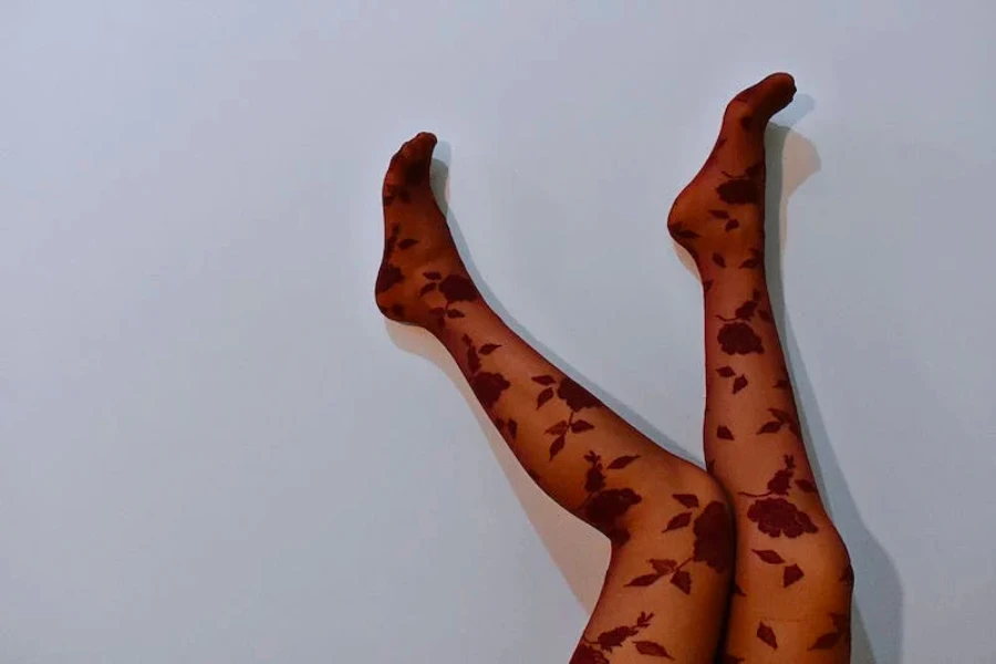 Two legs in the air with patterned flower tights