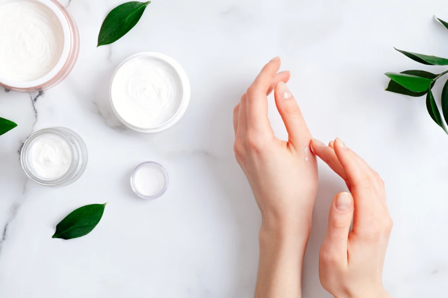 Woman applying moisturizing hand cream