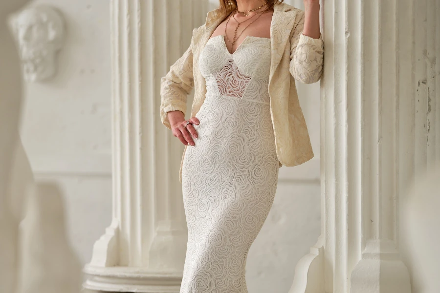 Woman in a white column dress and blazer