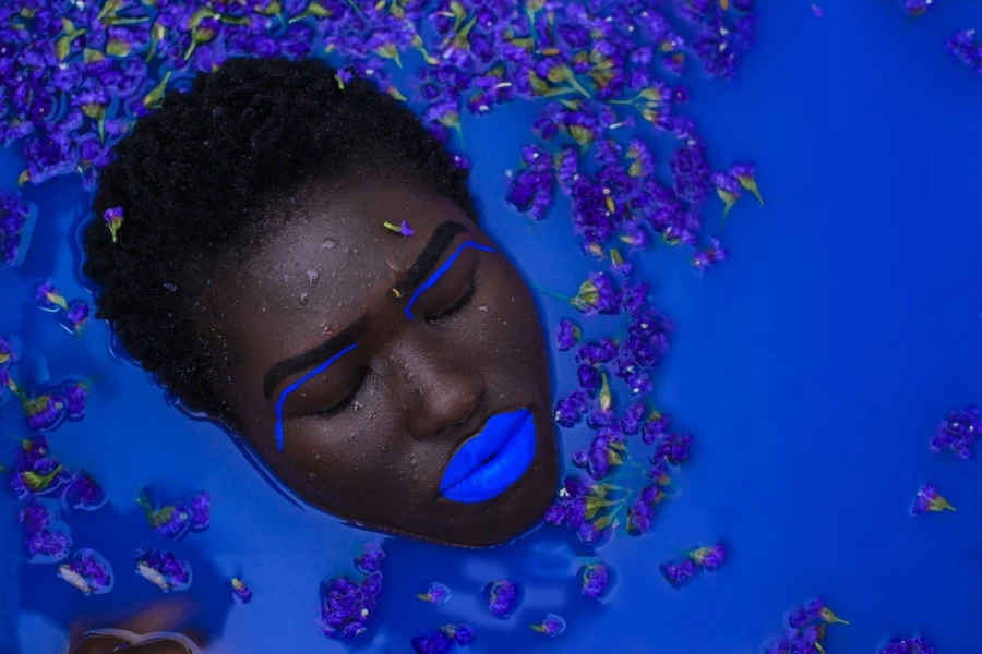 Woman in water wearing electric blue lipstick
