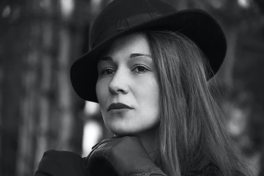 Woman wearing a cloche hat and black leather gloves