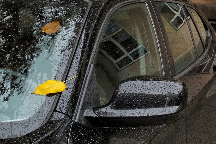 Une voiture noire sous la pluie