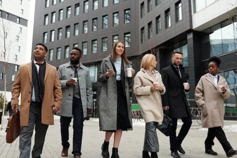 A group of people walking in different-style coats
