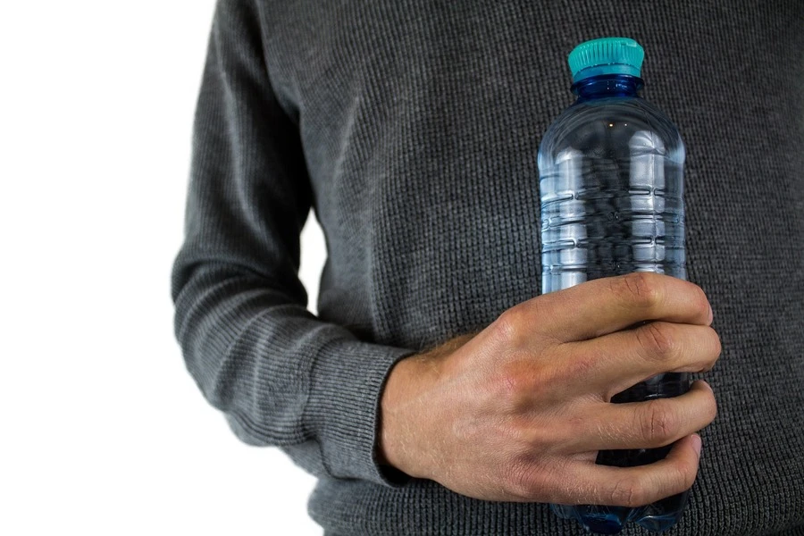 A man holding a plastic water bottle