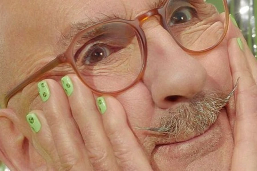 A man’s close-up with painted fingernails