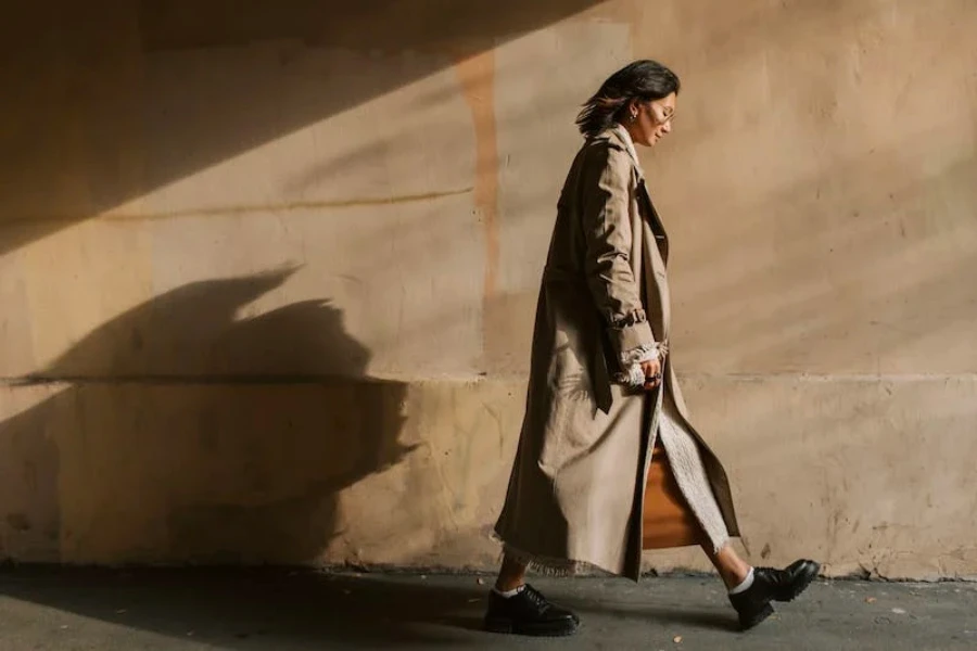 A woman walking wearing an oversized winter coat
