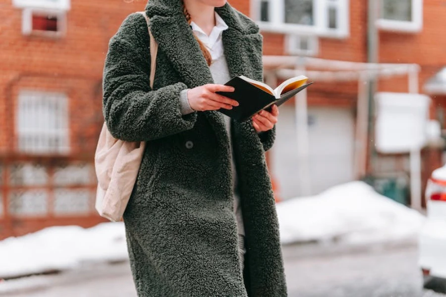 A woman wearing a fuzzy green coat