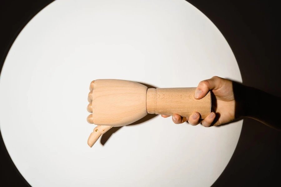 A wooden hand giving a thumbs down
