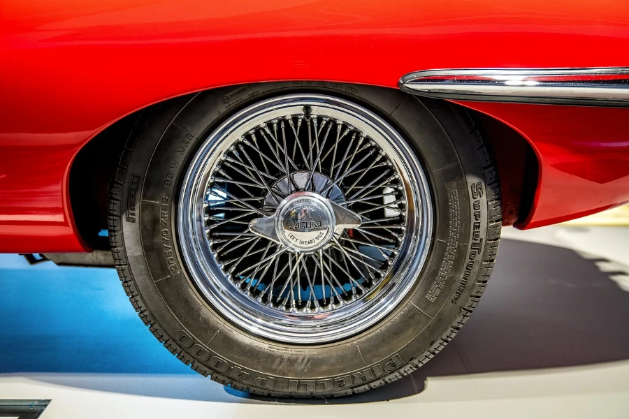 Closeup of a spoke wheel of a red car