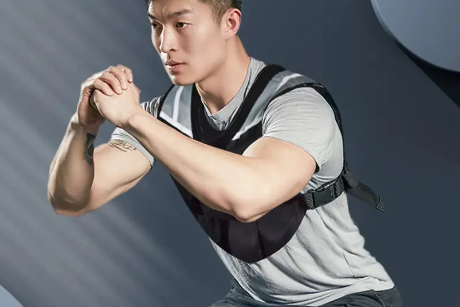 Man in gray t-shirt using a cropped weighted vest