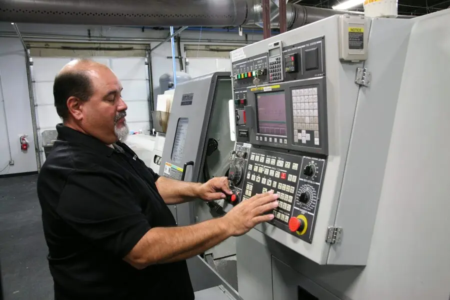 Operator running a CNC turning machine