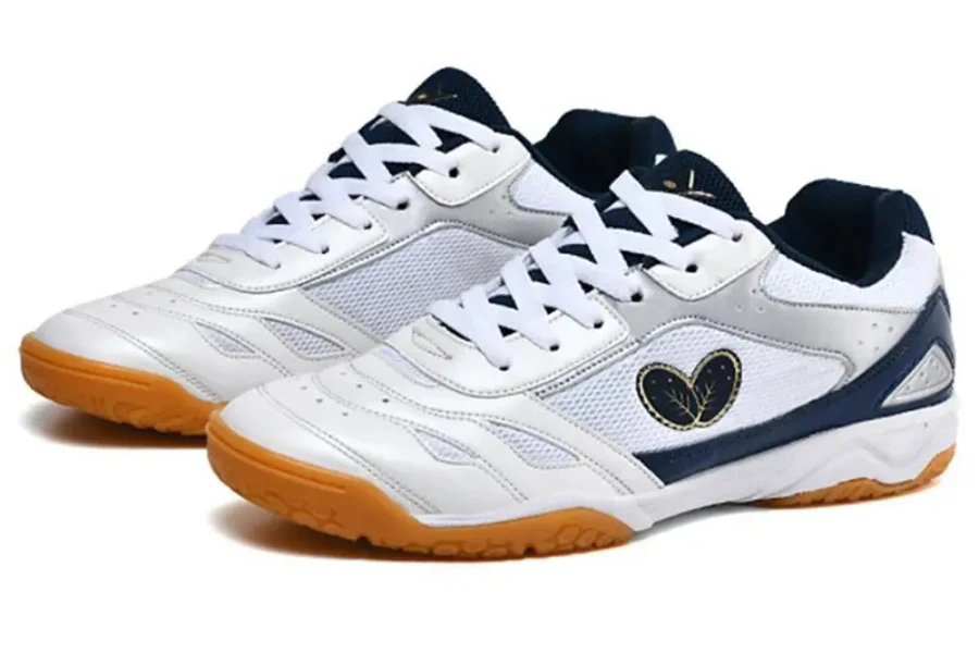Pair of white table tennis shoes with dark blue trim