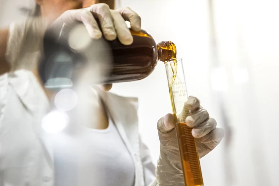 Perfumer holding a brown bottle and test tube