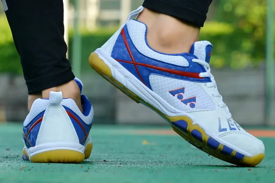Person wearing blue and white unisex table tennis shoes outside