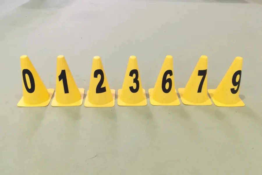 Row of yellow plastic cones with black numbers on them