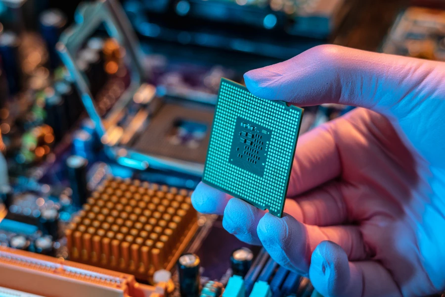 Technician inserting a CPU chip on a motherboard