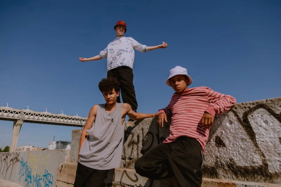 Three men outside with two wearing bucket hats