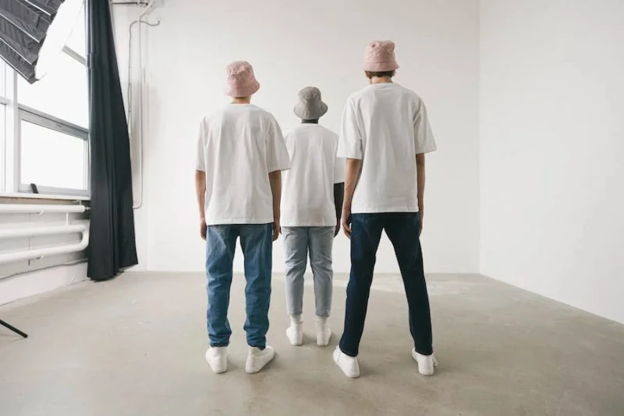 Three men wearing different-colored bucket hats