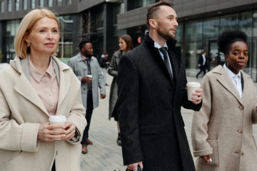 Three people walking wearing collared jackets