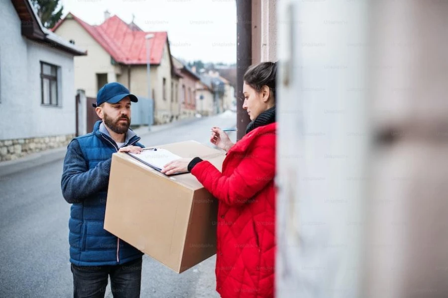 Woman on red sweater receiving a package