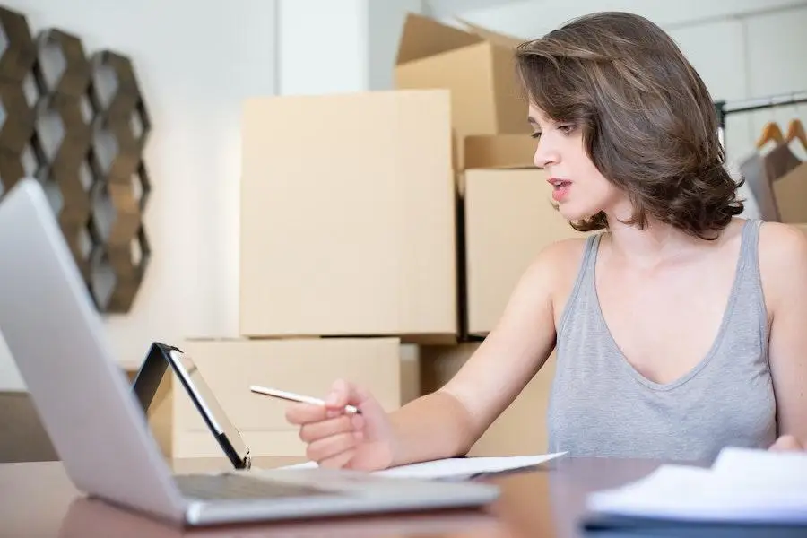 Woman staring at a phone screen while holding a pen