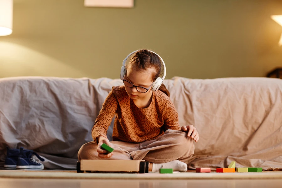 young child with headphones playing
